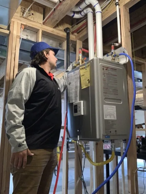 Harrison Riehle, founder of Flush My Tankless, on a tankless water heater job in Utah County